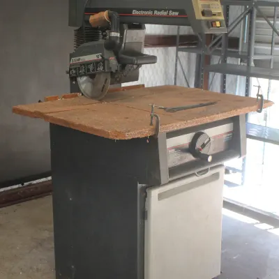 Craftsman 10-inch electronic radial arm saw, 2.5 HP, mounted on a rolling cabinet base with a wooden work surface.
