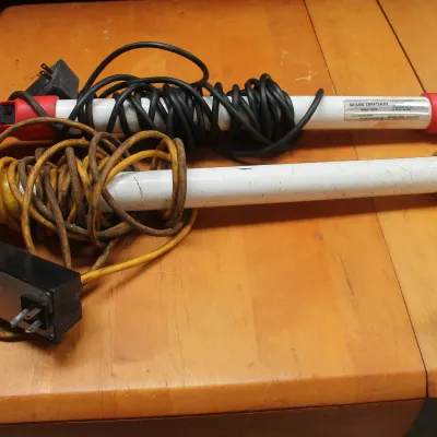 Two vintage Sears Craftsman fluorescent work lights with hanging hooks and power cords, showing signs of use.