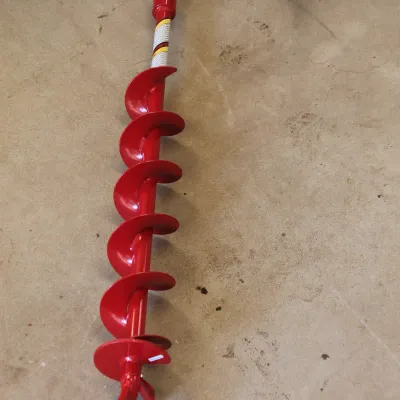 Red earth auger drill bit attachment, showing minimal wear and a clean painted finish.