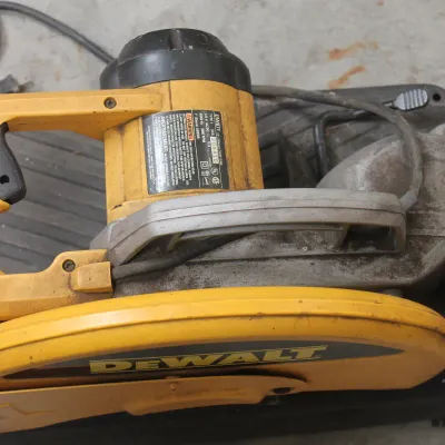 DeWalt DW871 14-inch metal chop saw, showing signs of moderate use and wear.