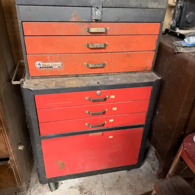 Vintage Rem Line two-piece rolling tool chest in red and black finish, showing some wear and surface rust from use.