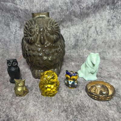 An Assortment of Seven Decorative Figurines and Objects Including Glass and Metal Owls and a Slag Glass Collie Dog