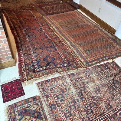 An Assortment of 8 Hand Made Tribal Rugs and Fragments