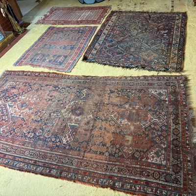 An Assortment of Four Antique and Vintage Hand Knotted Tribal Wool Rugs