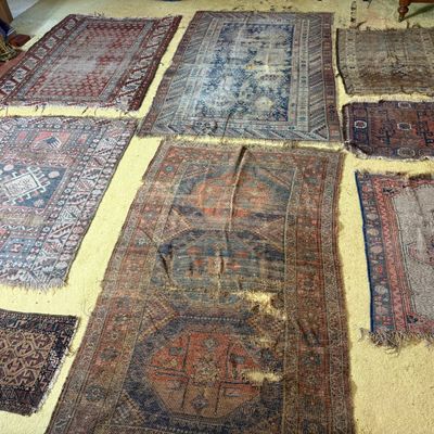 A Collection of Eight Antique and Semi-Antique Tribal and Village Rug Fragments