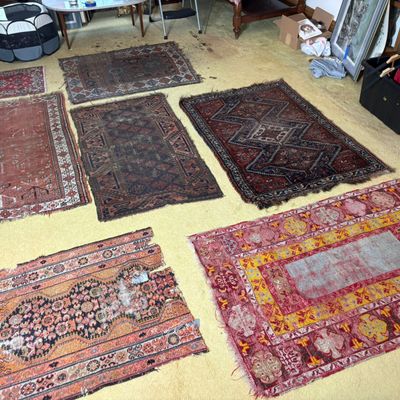A Collection of Seven Antique and Vintage Tribal Hand-Knotted Wool Rugs and Fragments