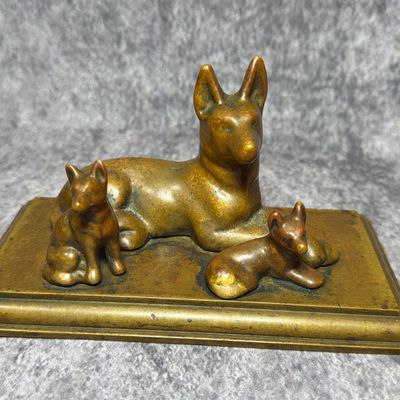 A Bronze Figural Group of a German Shepherd with Two Puppies