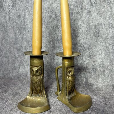 A Pair of Cast Brass Owl Motif Candle Holders with Drip Pans