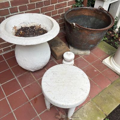 An Assortment of Antique and Rustic Garden Ornaments Including a Copper Cauldron and Concrete Urn