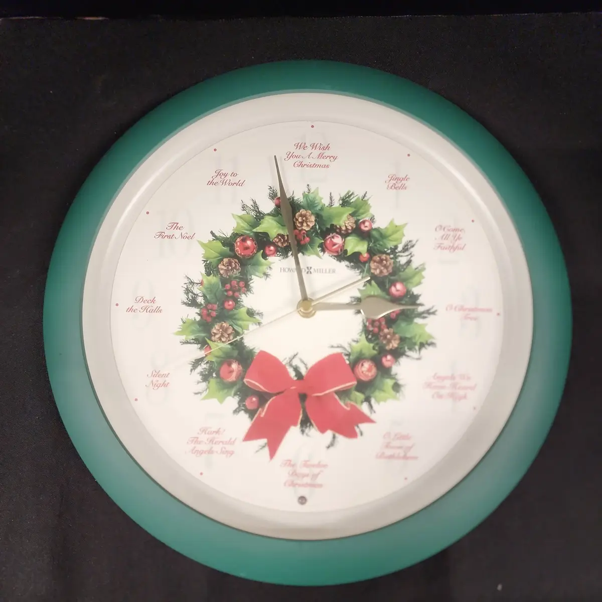 Howard Miller Musical Twelve Days Of Christmas Wall Clock -  Battery Operated, Green Frame, Plastic 