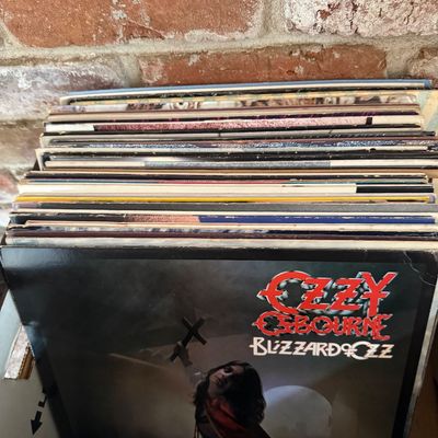 Ozzy Osbourne "Blizzard of Ozz" vinyl record album, showing some wear on the sleeve, fronting a stack of other vintage vinyl...