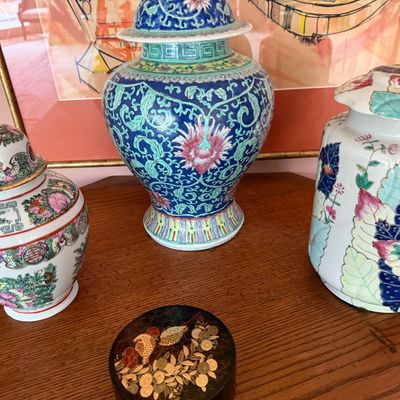 Collection of Asian decorative items, including three porcelain ginger jars with colorful floral motifs and a small round lacquer box...