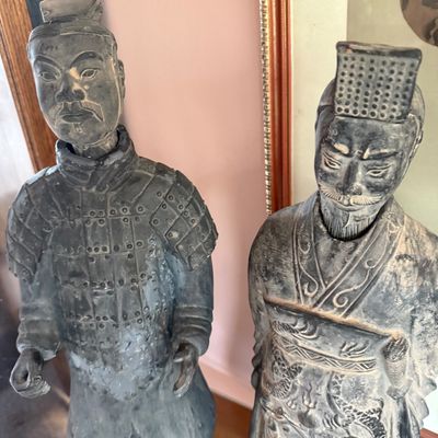 Pair of replica Chinese Terracotta Warrior statues, featuring detailed armor and robes with a weathered, antiqued finish.