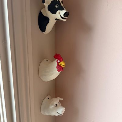 Set of three whimsical, hand-painted ceramic wall-hanging farm animal busts, featuring a cow, a rooster, and a pig.