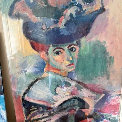 Framed art print of Henri Matisse's Fauvist masterpiece, "Woman with a Hat," featuring vibrant, non-naturalistic colors.