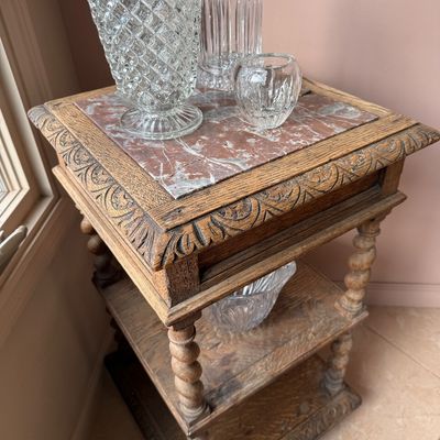 Antique carved oak three-tier side table featuring a pink marble inset top, barley twist legs, and ornate relief-carved borders.