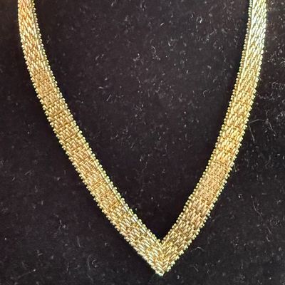 Vintage gold  woven mesh V-shaped collar necklace displayed on a black velvet bust.