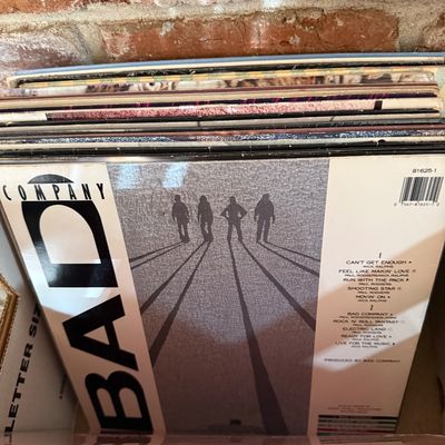 Bad Company self-titled vinyl record album, showing the back cover tracklist, stored in a collection box.