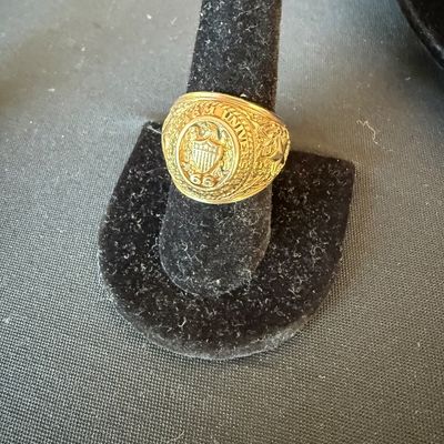 Vintage gold class ring from Southern Methodist University, dated 1966, displayed on a black velvet ring stand.