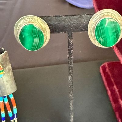 Pair of vintage sterling silver and malachite clip-on earrings featuring oval cabochons with a rope-twist border.