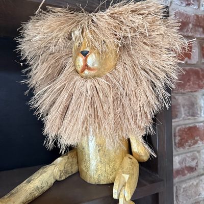 Vintage hand-painted wooden lion shelf sitter with a full raffia mane and jointed limbs.