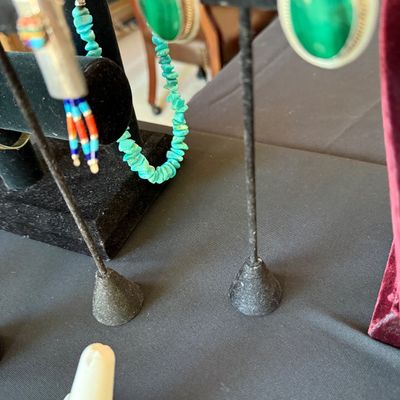 Southwestern-style jewelry display featuring a turquoise nugget necklace, a pair of oval green malachite earrings, and a beaded pendant...
