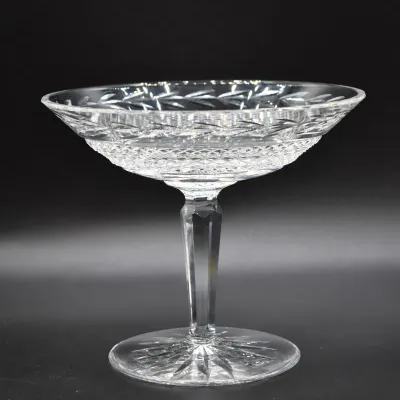 Vintage cut crystal compote bowl featuring a faceted stem and intricate geometric patterns, shown in excellent condition.