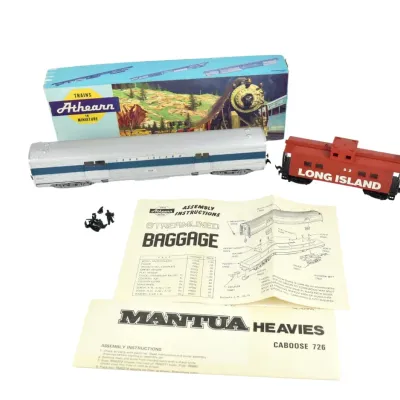 Vintage HO scale model train cars, including an Athearn Long Island streamlined baggage car with its original box and instructions, and a...
