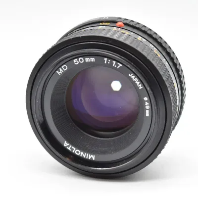 Vintage Minolta MD 50mm f/1.7 manual focus prime lens, made in Japan, featuring a 49mm filter thread and clean glass elements.