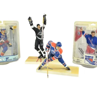 Collection of four Wayne Gretzky McFarlane's Sportspicks action figures, featuring him in St. Louis Blues, Los Angeles Kings,...