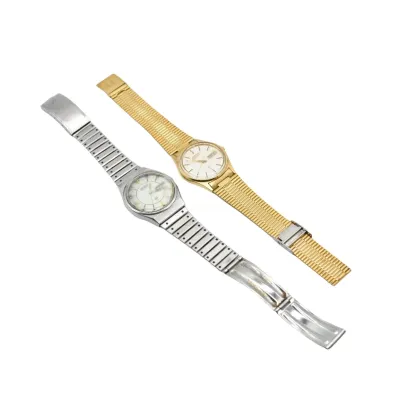 Two vintage Seiko quartz wristwatches, one in a silver-tone finish with a segmented metal band and the other in a gold-tone finish with a...