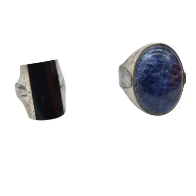 Two vintage sterling silver rings, one featuring a vertical black onyx inlay and the other set with a large oval sodalite cabochon.