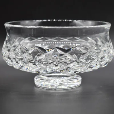 Vintage cut crystal pedestal bowl featuring a diamond pattern and a smooth, flared rim.