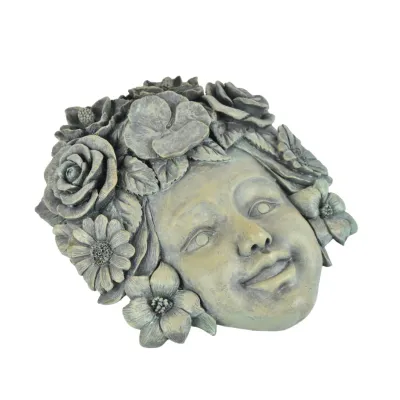 Cast stone garden wall plaque depicting a child's face framed by a crown of detailed flowers, featuring a weathered gray and green...