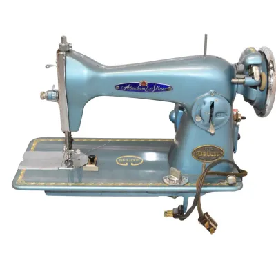 Vintage Abraham & Straus De Luxe sewing machine in a metallic blue finish, featuring gold-toned decals and chrome hardware, circa 1950s.