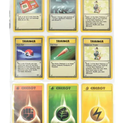 Vintage Pokémon trading cards, including Trainer and Energy cards, housed in a clear plastic binder sleeve.
