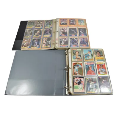 Two three-ring binders containing vintage baseball cards from the late 1970s and 1980s, organized in plastic pocket sleeves.