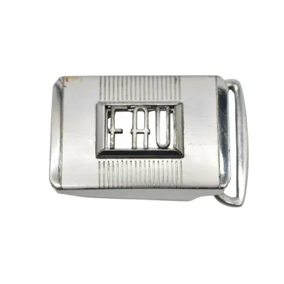 Vintage silver-tone metal belt buckle featuring the monogram "FAU" in a central cutout frame with vertical ribbed detailing.