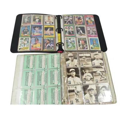 Two binders of vintage baseball cards, featuring 1980s Topps and Donruss cards in the top binder, and older black-and-white player cards...