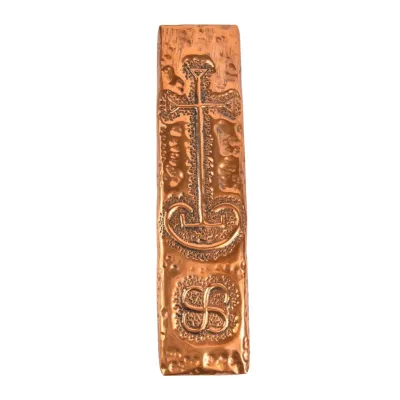 Vintage hammered copper mezuzah case featuring embossed traditional symbols and a textured finish.