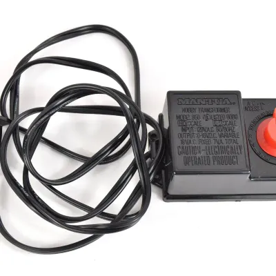 Mantua Model 850 hobby transformer for HO and N scale model trains, featuring a black plastic casing with a red control dial and attached...