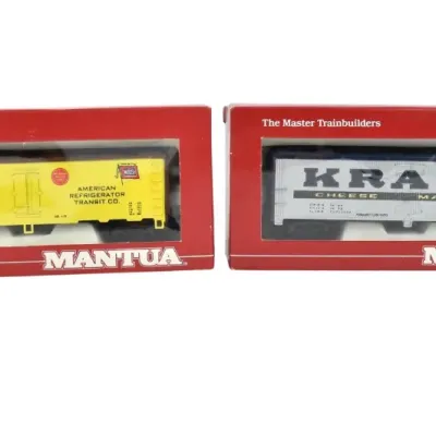 Two Mantua HO scale model train refrigerator cars in their original red boxes, featuring an American Refrigerator Transit Co. car and a...