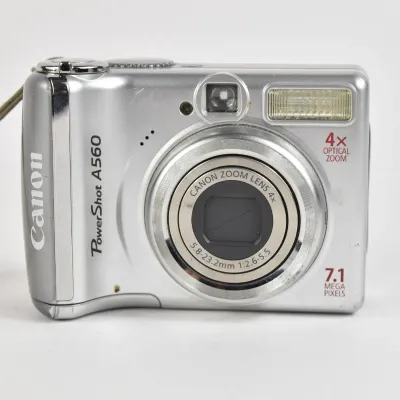 Canon PowerShot A560 digital camera, featuring 7.1 megapixels, a 4x optical zoom lens, and an attached wrist strap.