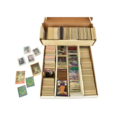 Large collection of vintage baseball cards, primarily from the 1980s and 1990s, organized in cardboard storage boxes with several loose...