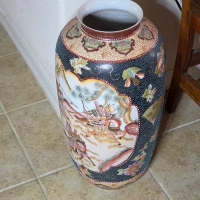 Large Satsuma-style ceramic floor vase featuring hand-painted scenes of samurai on horseback, accented with raised moriage details and...