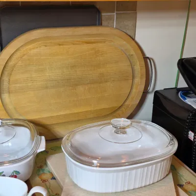 Vintage Corning Ware French White oval casserole dish with glass lid, shown alongside a floral patterned casserole dish and a large...