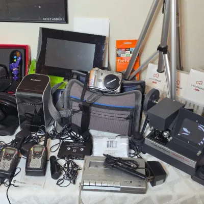 Assortment of vintage and modern electronics, including an Olympus digital camera with carrying case, a Mansfield Reporter 8mm film...