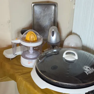 Assorted small kitchen appliances including a George Foreman Fusion Grill with glass lid, a Black & Decker CitrusMate Plus juicer,...