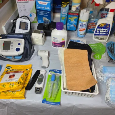 Assortment of household medical and cleaning supplies, including blood pressure monitors, thermometers, face masks, and various cleaning...