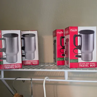 Four Fine Life Products 14-ounce stainless steel travel mugs in their original boxes, featuring a double-walled design and a 12V car...